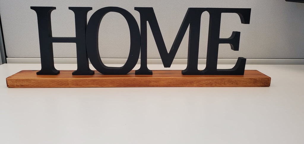 Freestanding black HOME sign with baseboard