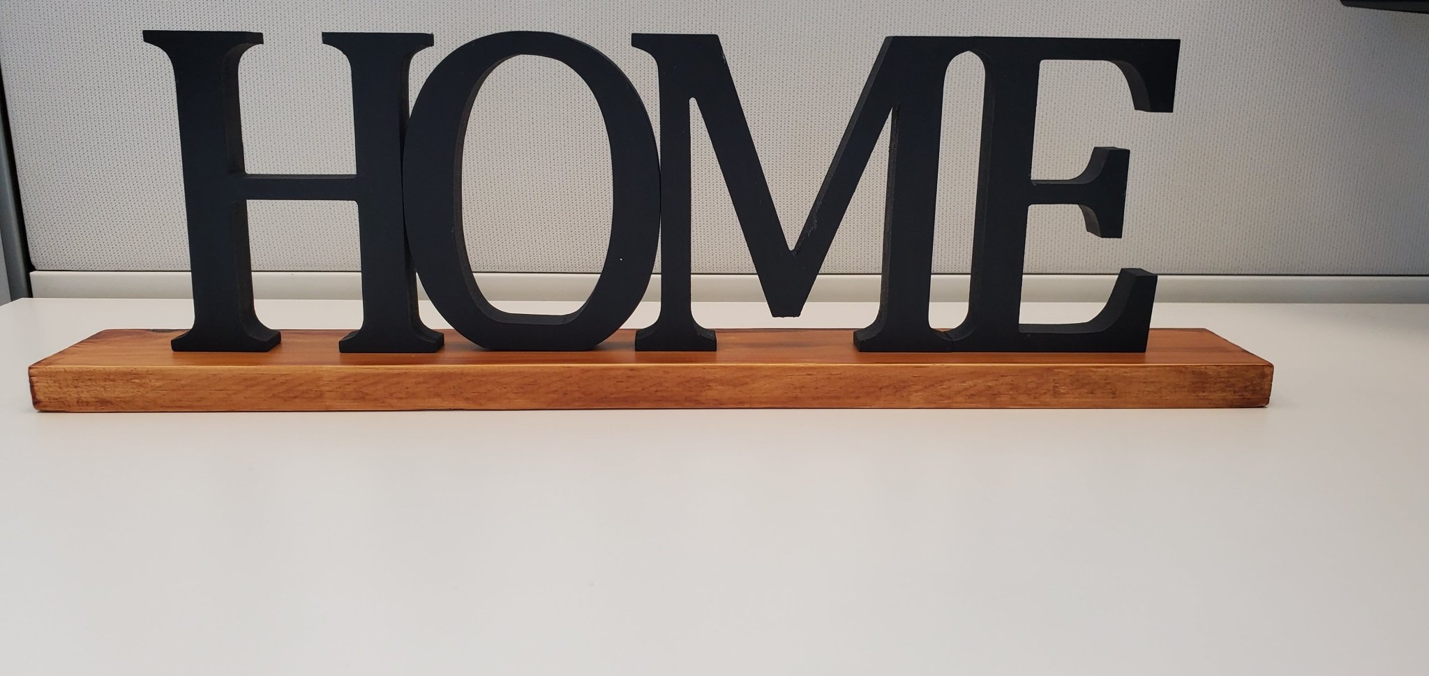 Freestanding black HOME sign with baseboard