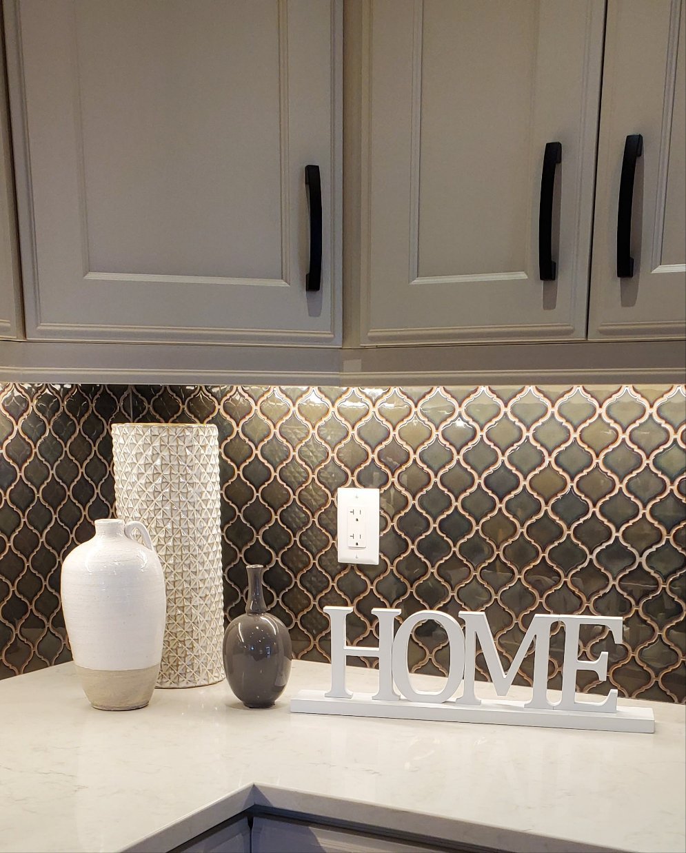White wooden HOME sign with decorative baseboard
