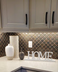 White wooden HOME sign with decorative baseboard