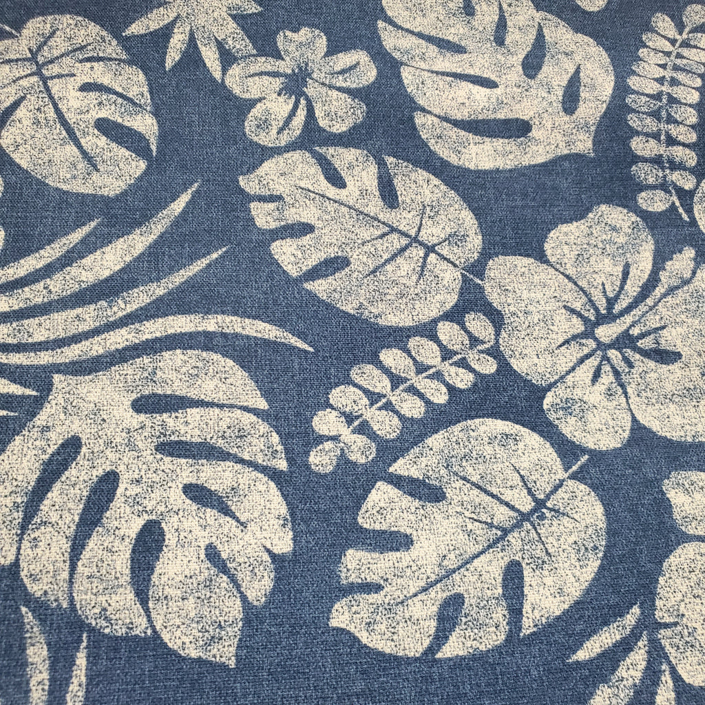 Tropical leaf pattern on a blue fabric background