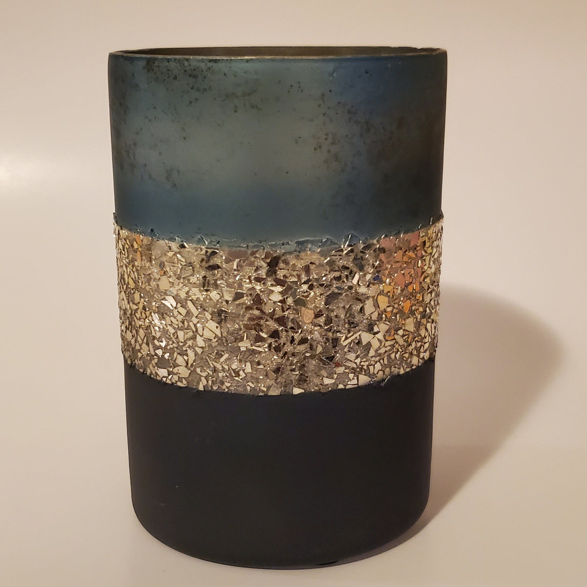 Two-toned blue and gold glass candle holder for elegant home décor warm light view