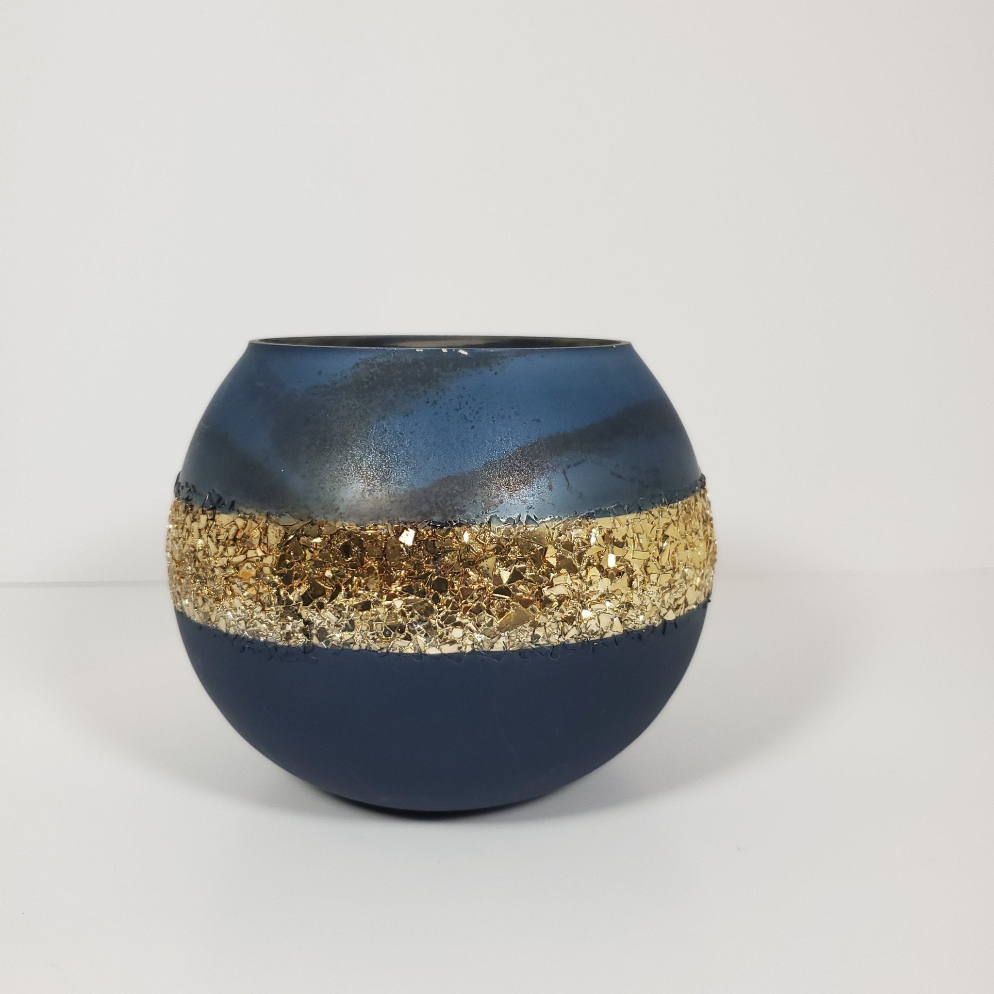 Blue and gold glass candle holder close up front view showing detail