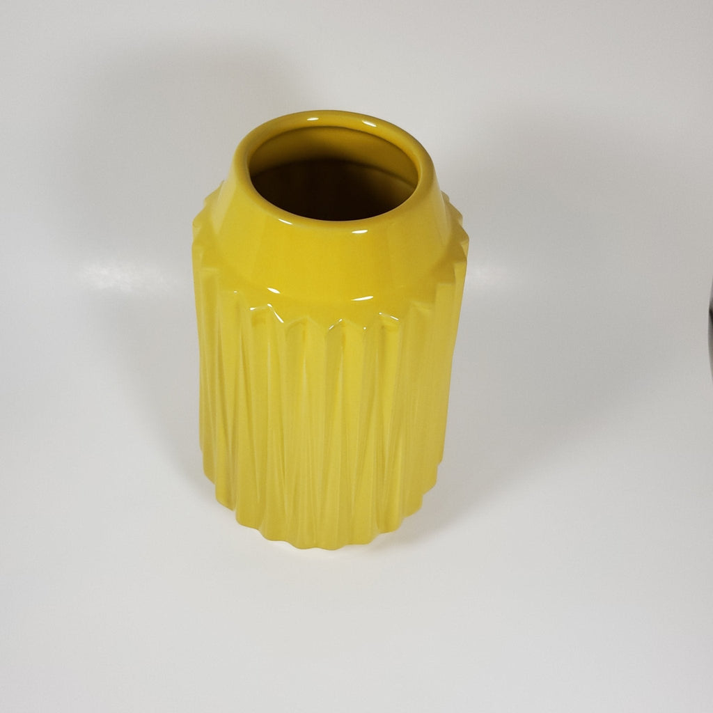 Sunshine yellow ribbed ceramic vase angled top view