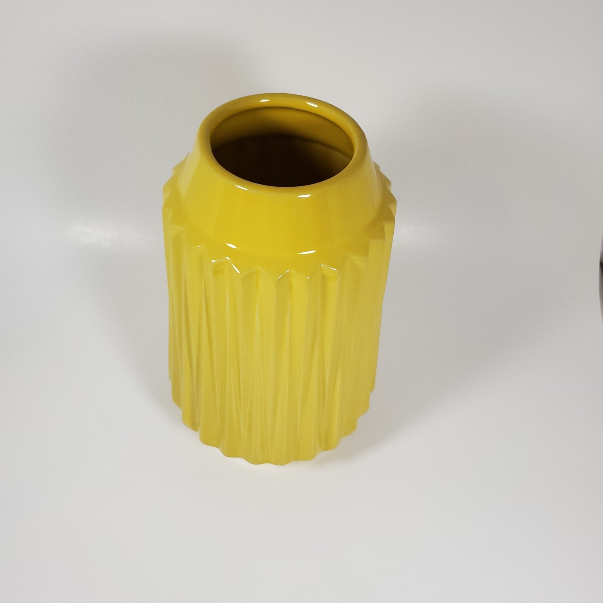 Sunshine yellow ribbed ceramic vase angled top view
