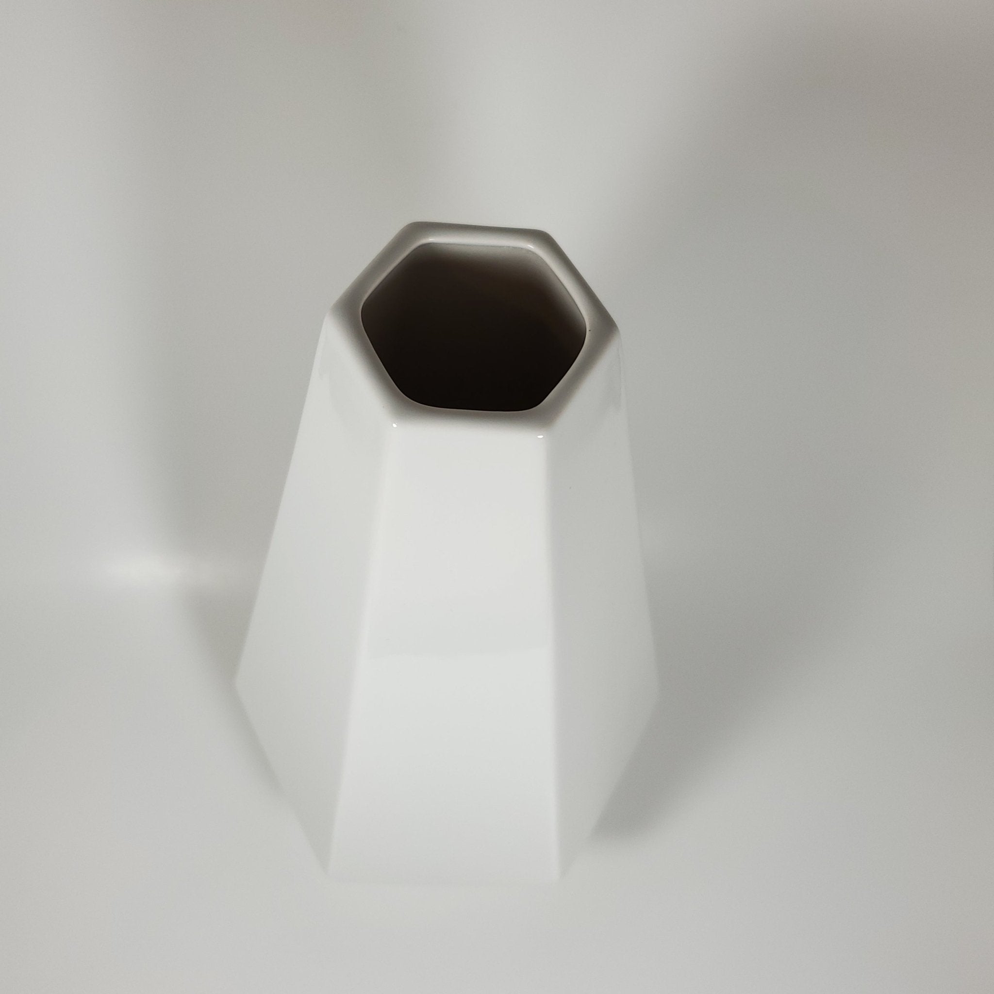 White geometric ceramic vase angled to view